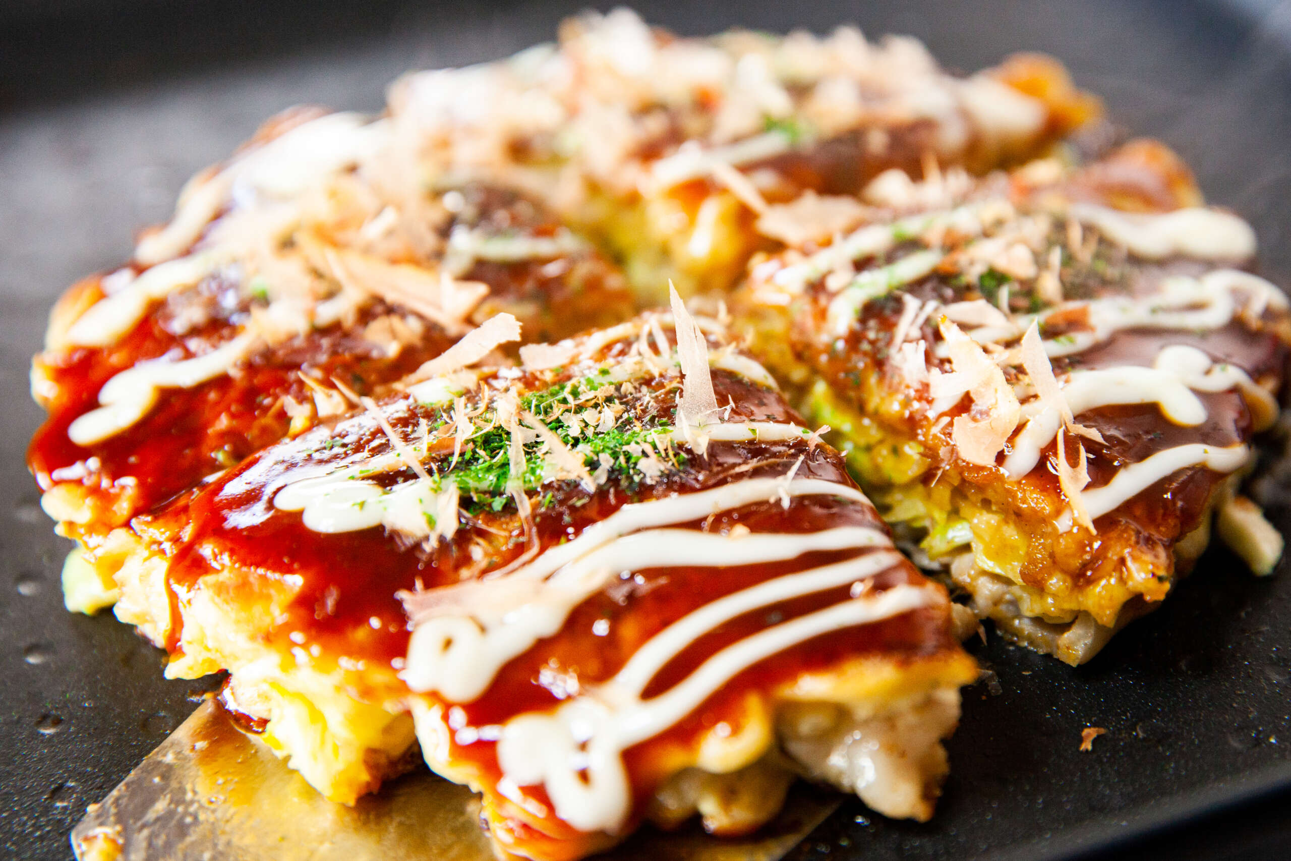okonomiyaki cooking class Osaka flipping a pancake